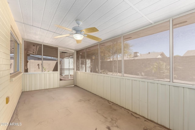 unfurnished sunroom with ceiling fan