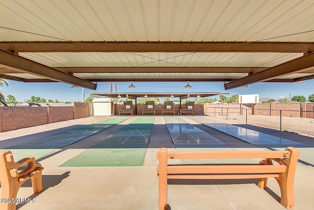 exterior space featuring shuffleboard and fence