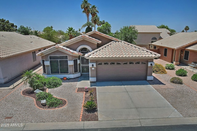 1741 S Clearview Ave Unit 13, Mesa, AZ 85209 - mediterranean / spanish house with an attached garage, driveway, a tile roof, and stucco siding