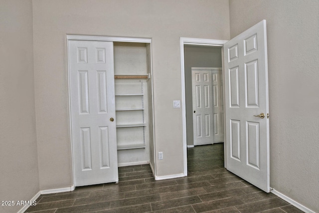 1741 S Clearview Ave Unit 13, Mesa, AZ 85209 - unfurnished bedroom with dark wood-type flooring and baseboards