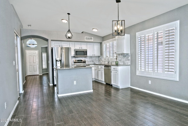 1741 S Clearview Ave Unit 13, Mesa, AZ 85209 - kitchen with stainless steel appliances, white cabinets, backsplash, a chandelier, and light stone countertops