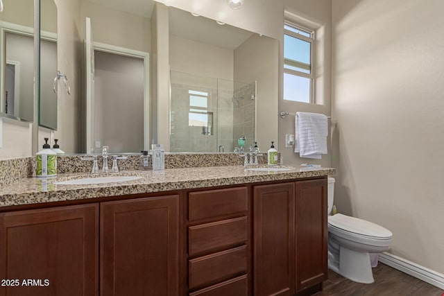 bathroom featuring vanity, toilet, hardwood / wood-style floors, and an enclosed shower