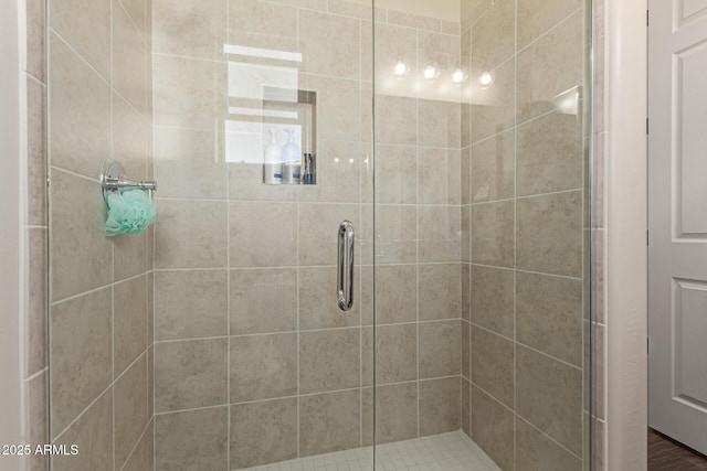 bathroom featuring a shower with door