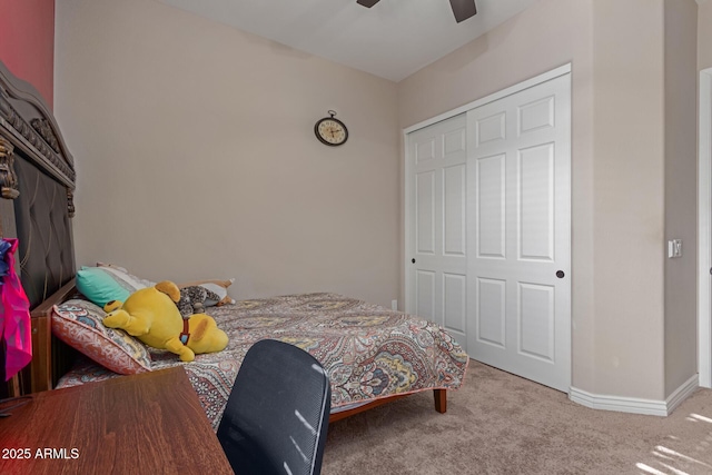 bedroom with ceiling fan, light colored carpet, and a closet