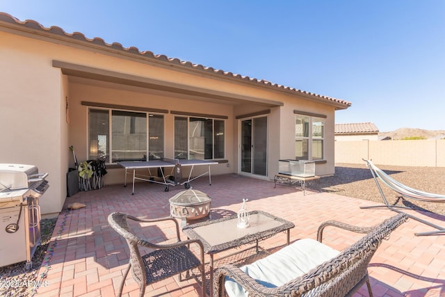 view of patio with an outdoor fire pit and grilling area