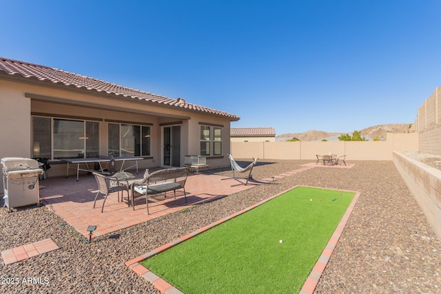 view of yard with a mountain view and a patio