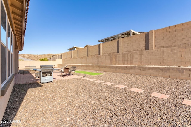 view of yard featuring a patio area and a mountain view