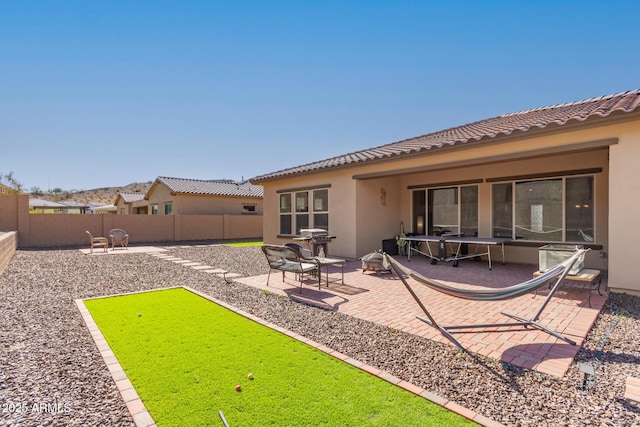 back of property with a patio