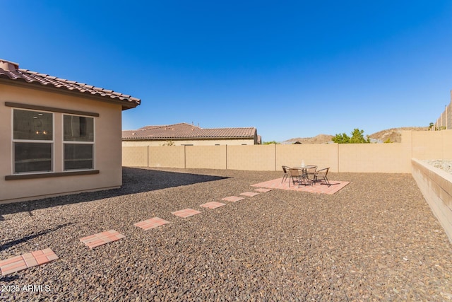 view of yard with a patio area and a mountain view