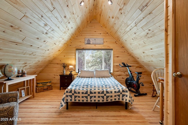 bedroom featuring lofted ceiling, wooden walls, wood ceiling, and wood finished floors