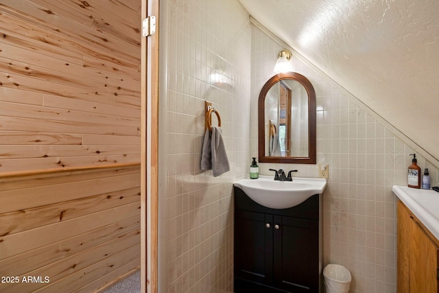 bathroom featuring tile walls and vanity