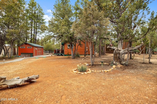 view of yard with a garage and an outdoor structure