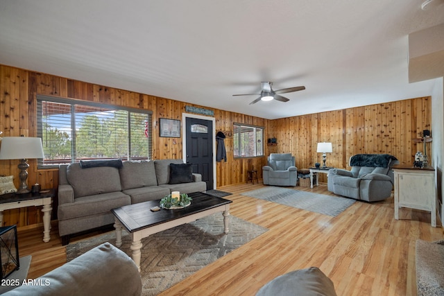 living room with a ceiling fan and wood finished floors