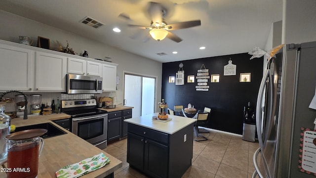 10036 W Chipman Rd, Tolleson, AZ 85353 - kitchen featuring stainless steel appliances, white cabinets, a ceiling fan, light countertops, and light tile patterned flooring