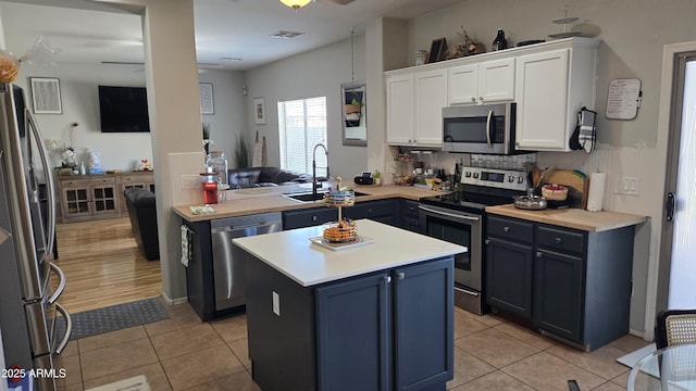 10036 W Chipman Rd, Tolleson, AZ 85353 - kitchen featuring stainless steel appliances, white cabinetry, light countertops, and light tile patterned flooring