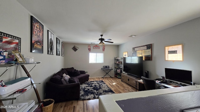 10036 W Chipman Rd, Tolleson, AZ 85353 - living area with light wood finished floors, ceiling fan, and a desk