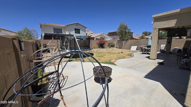 10036 W Chipman Rd, Tolleson, AZ 85353 - fenced backyard with a trampoline and a patio