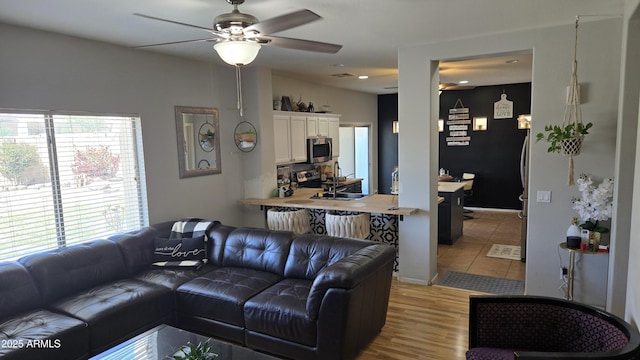 10036 W Chipman Rd, Tolleson, AZ 85353 - living room featuring a ceiling fan and light wood-type flooring