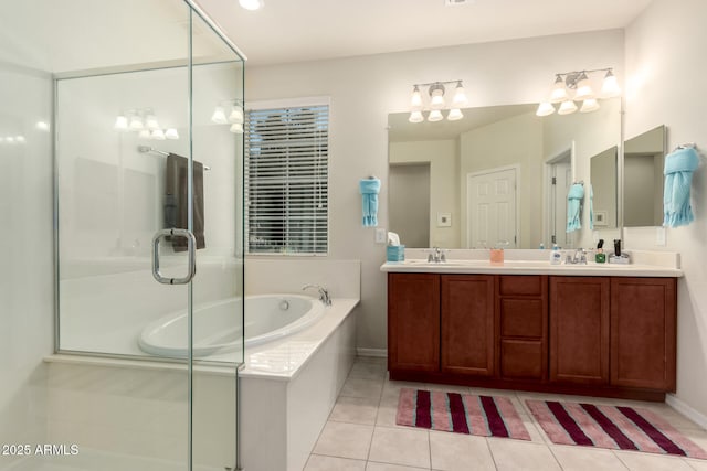 bathroom featuring vanity, tile patterned flooring, and shower with separate bathtub