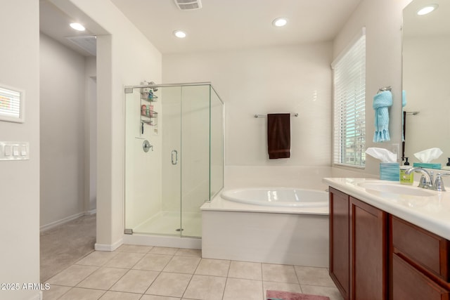 bathroom featuring tile patterned floors, vanity, and plus walk in shower