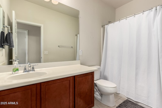 bathroom with toilet, tile patterned flooring, and vanity