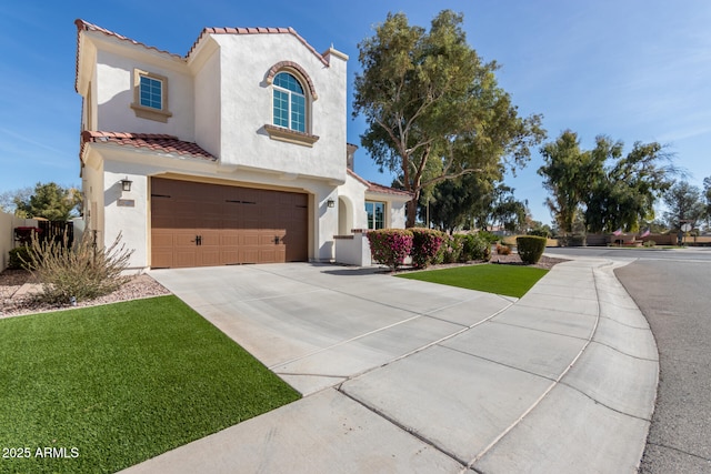 mediterranean / spanish-style home featuring a front lawn and a garage