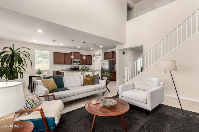 tiled living room with a towering ceiling