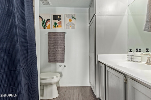 bathroom with toilet, vanity, baseboards, and a shower with curtain