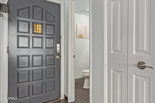 bathroom featuring toilet and baseboards