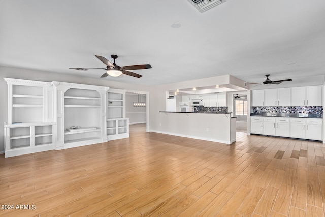 unfurnished living room with ceiling fan and light wood-type flooring