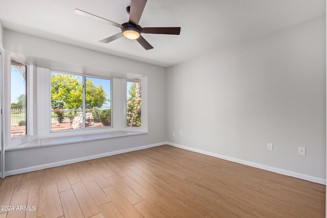 empty room with wood-type flooring and ceiling fan