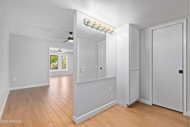 interior space featuring light hardwood / wood-style flooring, ceiling fan, and a textured ceiling