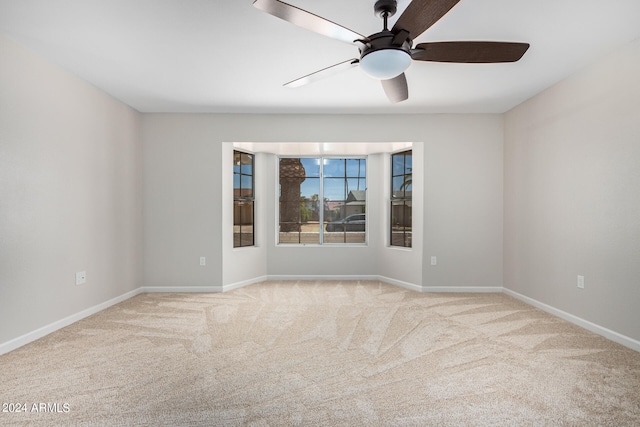 unfurnished room with carpet and ceiling fan