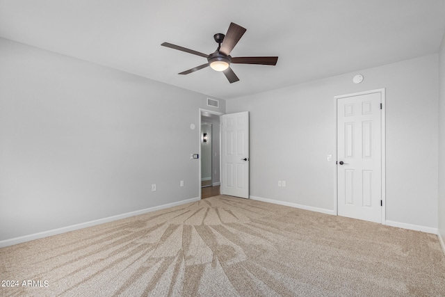 carpeted spare room with ceiling fan