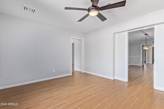 empty room with light hardwood / wood-style flooring and ceiling fan