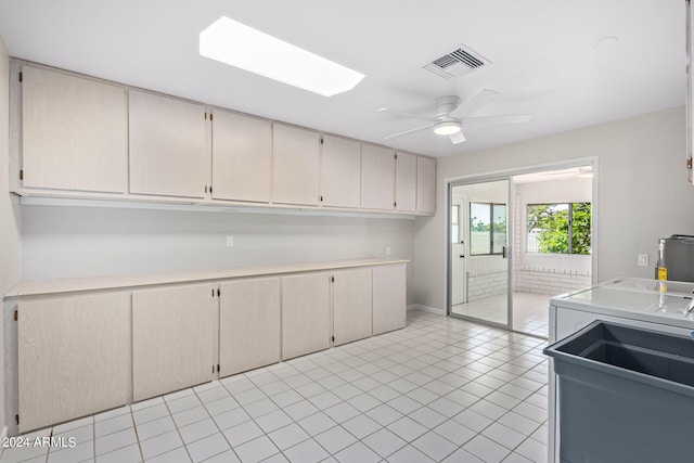 kitchen with cream cabinets, ceiling fan, and light tile floors