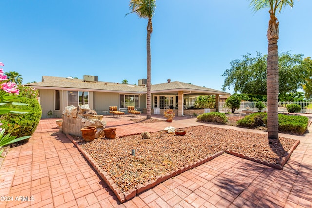 rear view of property featuring a patio area