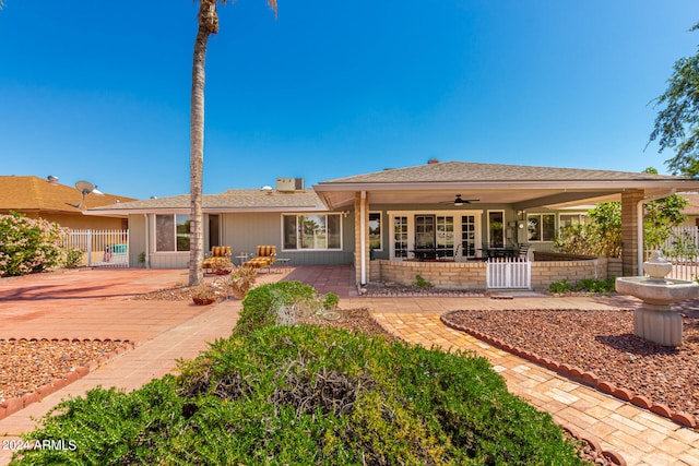 rear view of property with ceiling fan