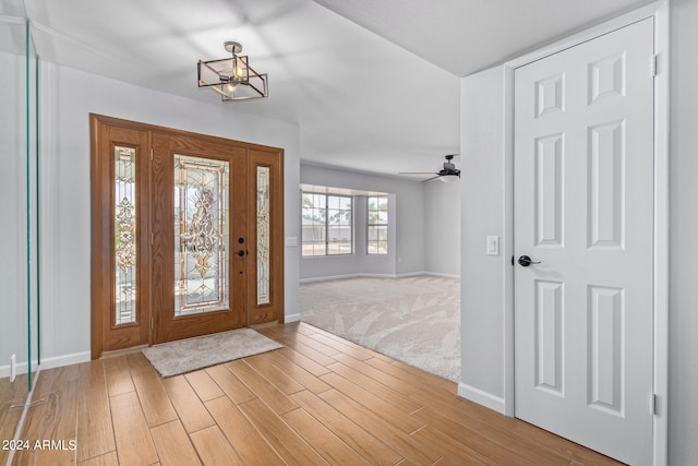 carpeted entryway featuring ceiling fan