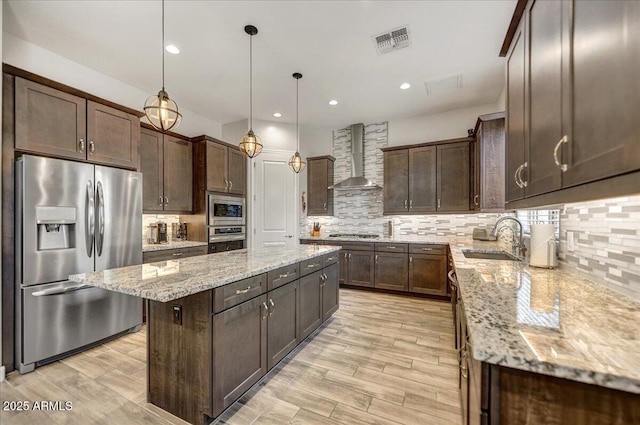 6503 E Bluefield Ave, Phoenix, AZ 85054 - kitchen with stainless steel appliances, a sink, wall chimney range hood, dark brown cabinets, and recessed lighting