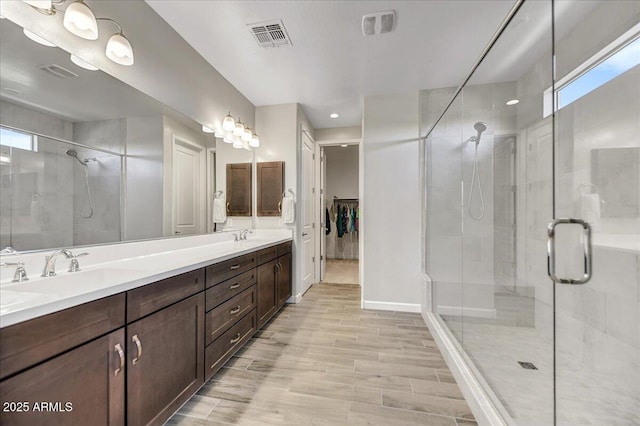 6503 E Bluefield Ave, Phoenix, AZ 85054 - bathroom with a stall shower, double vanity, wood finished floors, and baseboards