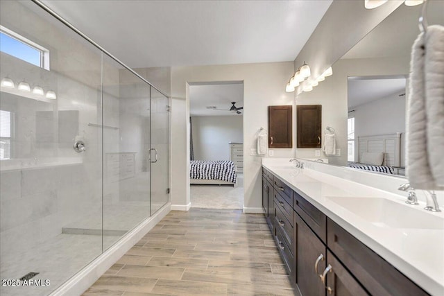 6503 E Bluefield Ave, Phoenix, AZ 85054 - ensuite bathroom featuring double vanity, ceiling fan, a stall shower, wood finished floors, and baseboards