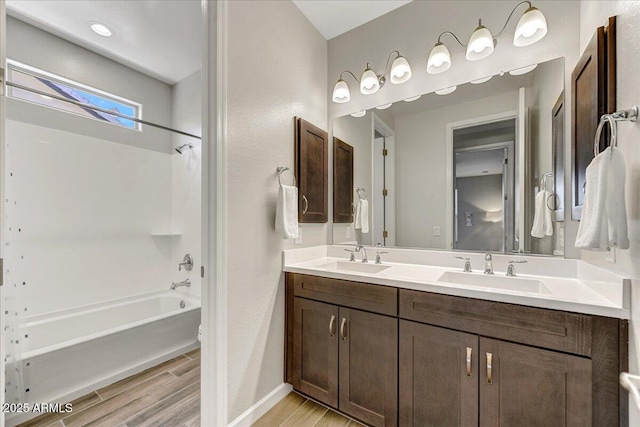 6503 E Bluefield Ave, Phoenix, AZ 85054 - bathroom with wood finished floors, shower / bath combination, baseboards, and double vanity