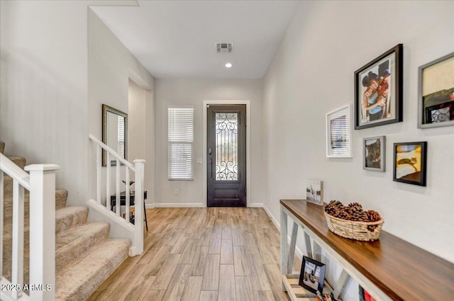 6503 E Bluefield Ave, Phoenix, AZ 85054 - foyer with stairway, light wood-style floors, and baseboards