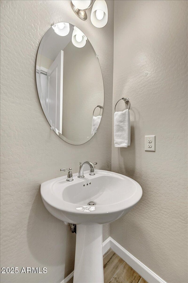 6503 E Bluefield Ave, Phoenix, AZ 85054 - bathroom with baseboards and wood finished floors