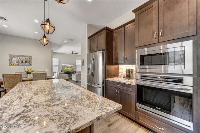 6503 E Bluefield Ave, Phoenix, AZ 85054 - kitchen featuring appliances with stainless steel finishes, light stone counters, dark brown cabinets, light wood-type flooring, and recessed lighting