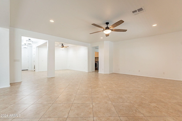 empty room featuring light tile patterned flooring and ceiling fan