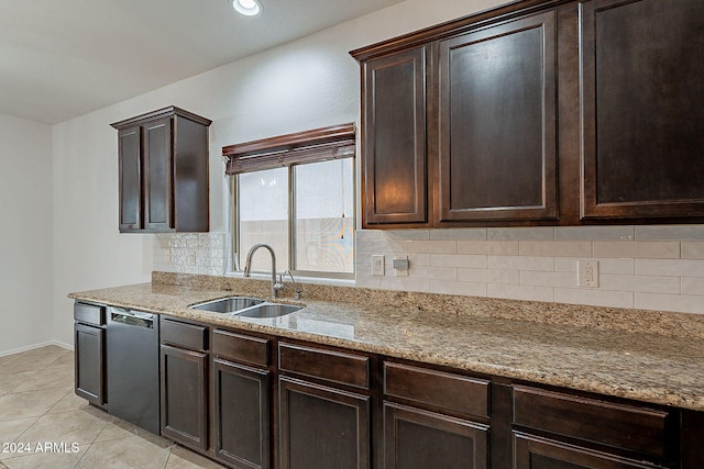 kitchen featuring light stone counters, dishwasher, dark brown cabinetry, sink, and tasteful backsplash