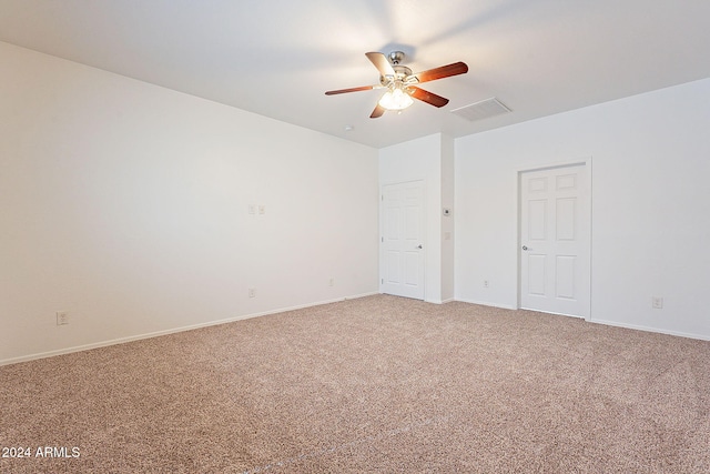 carpeted spare room with ceiling fan