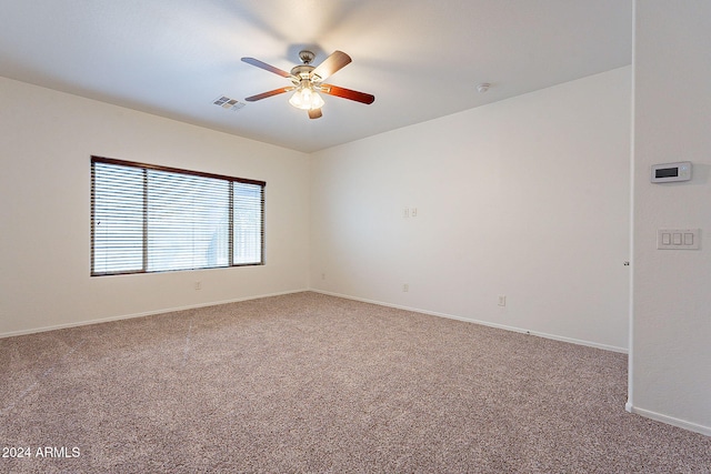 unfurnished room featuring ceiling fan and carpet floors